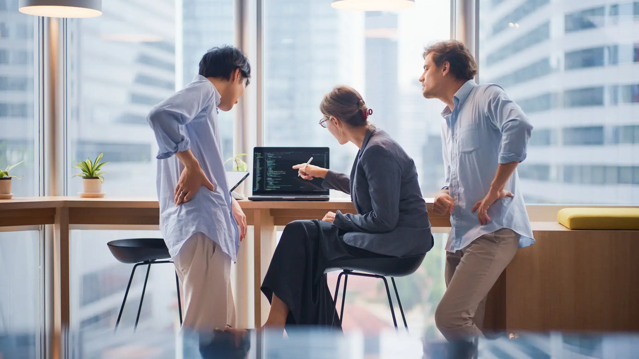 Colleagues discussing code on computer
