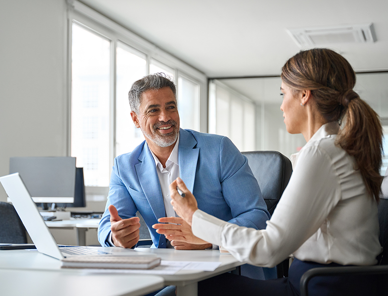 Colleagues discussing business in office